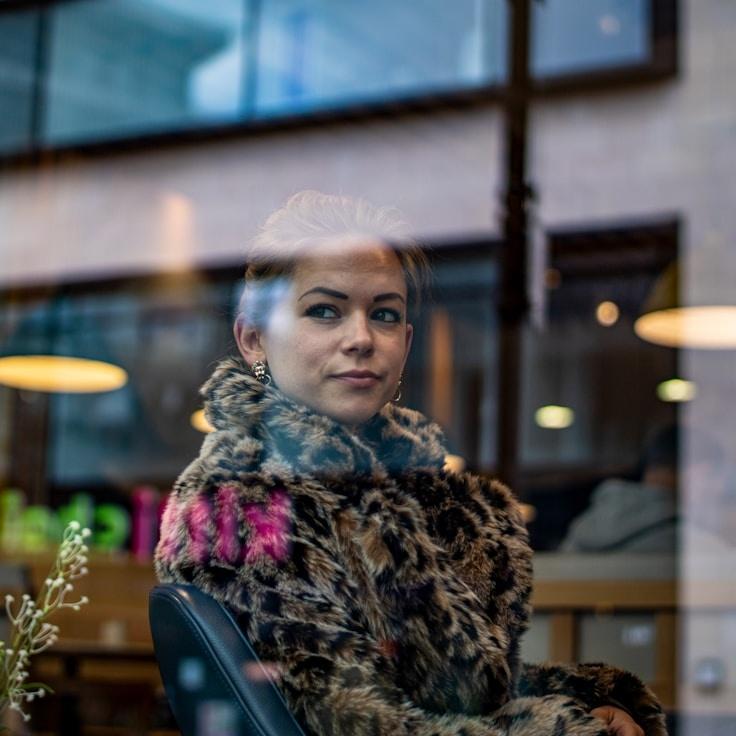 Avery Chen, Lead Design Curator at Fabric Bridge Orchard, reviewing corporate floral arrangements